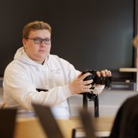 person som håller i en kamera